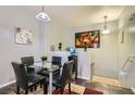 Bright dining area with a glass table, stylish chairs, and modern decor at 6321 Rolling Rose St # 201, North Las Vegas, NV 89081
