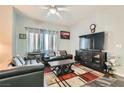 The living room has a dark leather sofa, large windows, and modern decor at 6321 Rolling Rose St # 201, North Las Vegas, NV 89081