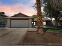 Charming single-story home featuring a well-manicured lawn, desert landscaping, and a two-car garage at 6436 Vinecrest Ave, Las Vegas, NV 89108
