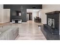 An open-concept living room is adjacent to the dining area and features a fireplace at 6436 Vinecrest Ave, Las Vegas, NV 89108