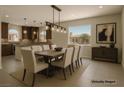 The dining room offers a large table, modern lighting, and a view of the outdoors at 6507 Creekside Cellars Ct, Las Vegas, NV 89139