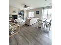 Open concept living room and dining area with wood flooring and plenty of natural light at 6812 Dipper Ave, North Las Vegas, NV 89084