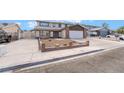 Inviting two-story home featuring a spacious driveway and a well-maintained front yard at 7009 Rawlins Ct, Las Vegas, NV 89128