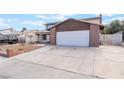 Inviting two-story home featuring a spacious driveway and a well-maintained front yard at 7009 Rawlins Ct, Las Vegas, NV 89128