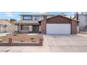 Inviting two-story home featuring a spacious driveway and a well-maintained front yard at 7009 Rawlins Ct, Las Vegas, NV 89128