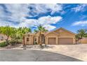 Charming home with a well-manicured front yard, mature palms and a two-car garage at 7427 Page Ranch Ct, Las Vegas, NV 89131