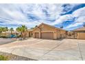 Spacious home featuring mature landscaping and a long driveway leading to the garage at 7427 Page Ranch Ct, Las Vegas, NV 89131