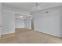 Living room with neutral carpet and a view of a doorway, closet, and tiled area at 8000 Badura Ave # 2174, Las Vegas, NV 89113