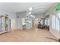 Open-concept living room featuring vaulted ceilings, wood floors, and a view into the kitchen and dining area at 8450 Alta Dr # 204, Las Vegas, NV 89145