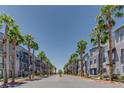 Street view showing palm tree lined street and building exteriors on either side at 9050 W Tropicana Ave # 1170, Las Vegas, NV 89147