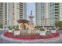 Elaborate fountain with lush landscaping and circular driveway situated between high-rise condominiums at 9103 Alta Drive Dr # 407, Las Vegas, NV 89145