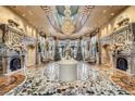Exquisite lobby with ornate marble floors, decorative fireplaces, crystal chandeliers, and elegant seating at 9103 Alta Drive Dr # 407, Las Vegas, NV 89145
