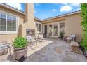 Cozy outdoor patio with stone flooring, fireplace, and comfortable seating, ideal for relaxing evenings at 9375 Gold Lake Ave, Las Vegas, NV 89149
