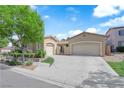 Charming single-story home featuring a three-car garage and meticulously landscaped front yard at 9375 Gold Lake Ave, Las Vegas, NV 89149