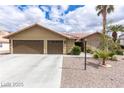 Inviting one-story home with a two-car garage and desert-style landscaping at 10058 Saint Augustine St, Las Vegas, NV 89183