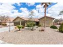 Charming single-story home with desert landscaping and a two-car garage at 10058 Saint Augustine St, Las Vegas, NV 89183