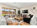 Inviting living room with comfortable seating, a large window offering natural light and a view of the outdoor space at 10906 Mila Landing Ave, Las Vegas, NV 89166
