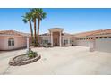 Charming single Gathering home showcases a circular driveway and lush landscaping at 1105 Malachite Ct, Henderson, NV 89011