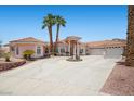 Charming single Gathering home showcases a circular driveway and lush landscaping at 1105 Malachite Ct, Henderson, NV 89011