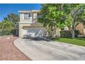 Well-maintained two-story home with a spacious driveway, manicured lawn, and mature trees on a sunny day at 1116 Avellino Ln, Las Vegas, NV 89144