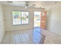 Inviting living room features tile flooring, an open front door, and plenty of natural light from the window at 129 Maple St, Henderson, NV 89015