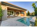 Outdoor living space with a pristine pool, patio furniture, and meticulously maintained landscaping at 15 Reflection Bay Dr, Henderson, NV 89011