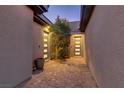 Courtyard area featuring brick pavers, a tree, and doors leading to the home's interior at 15 Reflection Bay Dr, Henderson, NV 89011