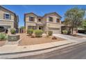 Inviting two-story home with gravel landscaping and a driveway leading to an attached garage at 184 Bird Cove Ave, Henderson, NV 89011