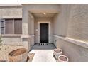 Welcoming front door with decorative metalwork, leading to a covered porch and entryway at 184 Bird Cove Ave, Henderson, NV 89011