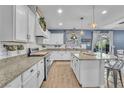 Bright, modern kitchen with white cabinets, granite countertops, and stainless steel appliances at 184 Bird Cove Ave, Henderson, NV 89011