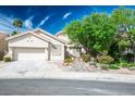 Charming single-story home featuring stucco exterior, tile roof, and well-manicured desert landscaping at 1978 Kachina Mountain Dr, Henderson, NV 89012