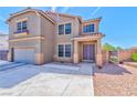 A charming two-story home with a desert landscape, a two-car garage, and a welcoming double-door entrance at 201 Palmarosa St, Henderson, NV 89015