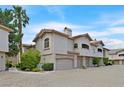 Exterior view of a modern townhome featuring multiple garage spaces and well-maintained landscaping at 2050 W Warm Springs Rd # 823, Henderson, NV 89014