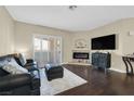 Inviting living room with fireplace, sliding doors to the outside, and stylish furnishings at 2050 W Warm Springs Rd # 823, Henderson, NV 89014
