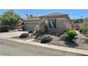 Single story home with desert landscape, two car garage, and inviting curbside appeal at 2138 Grand Traverse St, Henderson, NV 89052