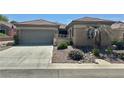 Charming single story home boasts desert landscaping, a two-car garage, and covered entry at 2138 Grand Traverse St, Henderson, NV 89052