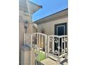 Exterior view shows a charming entryway with a gated porch and desert landscape at 2138 Grand Traverse St, Henderson, NV 89052