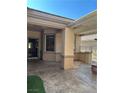 Covered outdoor patio with stamped concrete flooring and space for outdoor seating at 2138 Grand Traverse St, Henderson, NV 89052