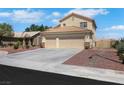 Charming two-story home boasts a spacious three-car garage and a well-maintained front yard with rock landscaping at 2684 Korea Ct, Henderson, NV 89052