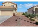 A well-maintained home with rock landscaping, showing the entrance to the back yard at 2684 Korea Ct, Henderson, NV 89052