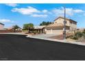 A comfortable two-story home with desert landscaping sits at the end of a cul-de-sac at 2684 Korea Ct, Henderson, NV 89052