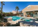Stunning backyard with a sparkling pool, spa, and outdoor seating area for relaxation at 2713 Tanagrine Dr, North Las Vegas, NV 89084