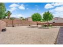 Spacious backyard with desert rock landscaping and a brick perimeter fence for privacy at 3102 Honeysuckle Ave, North Las Vegas, NV 89031