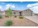 Charming single-story home with a desert rock landscape and a spacious two-car garage at 3102 Honeysuckle Ave, North Las Vegas, NV 89031