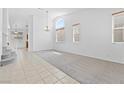 Bright living room with a large arched window, tile flooring, and neutral tones creating a welcoming space at 3273 Alcudia Bay Ave, Las Vegas, NV 89141