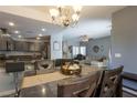 Open-concept dining area with seating for six flowing into a cozy living space at 3728 Juanita May Ave, North Las Vegas, NV 89032