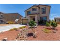 Charming two-story home with a three-car garage, desert landscaping and a small bridge feature at 3821 E Summit Ave, Pahrump, NV 89061