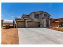 Charming two-story home with a three-car garage, desert landscaping and a long driveway at 3821 E Summit Ave, Pahrump, NV 89061