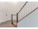 Hallway with a staircase, wood floors, neutral paint and a white front door at 3821 E Summit Ave, Pahrump, NV 89061