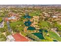 Expansive aerial view showcasing a luxury community with lush landscaping, water features, and a golf course at 5162 Estasi St, Las Vegas, NV 89135